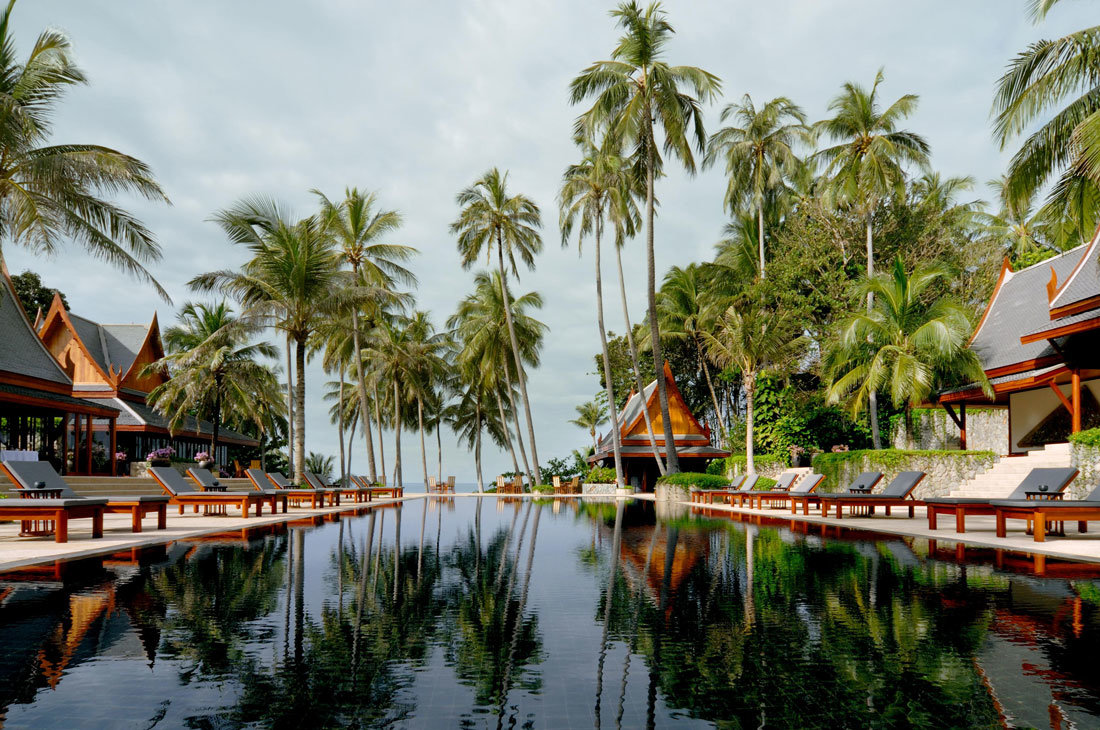 a resort spa pool with distant coconut trees