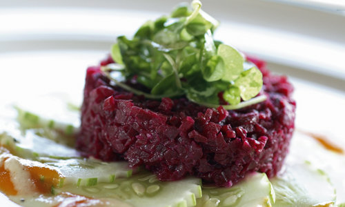 a salad with red turnip, green leaves and cucumber 