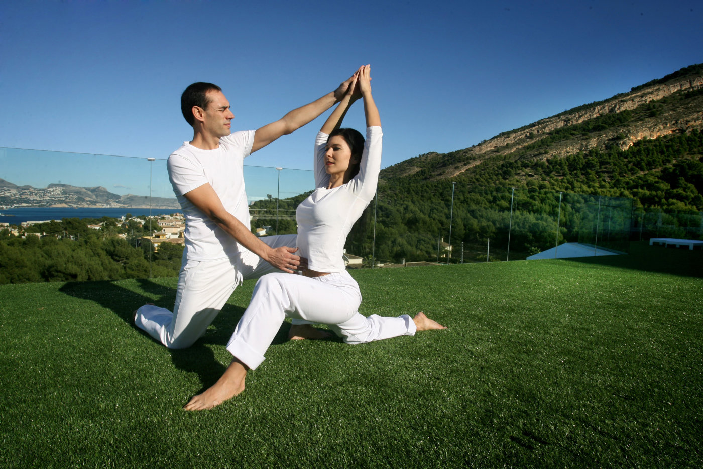 a man teaching yoga to a female student
